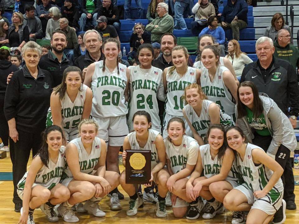 Girls basketball team poses with district trophy
