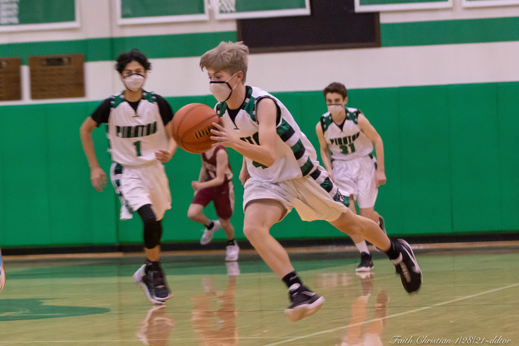 Student athlete dribbling a basketball.