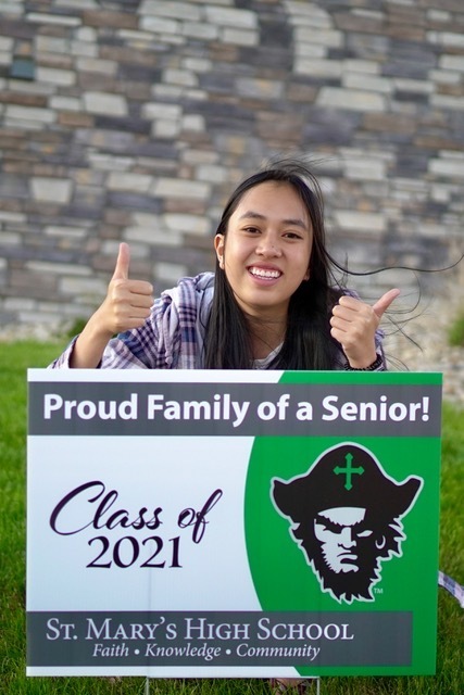 senior with a yard sign