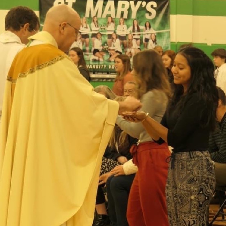 student receives communion