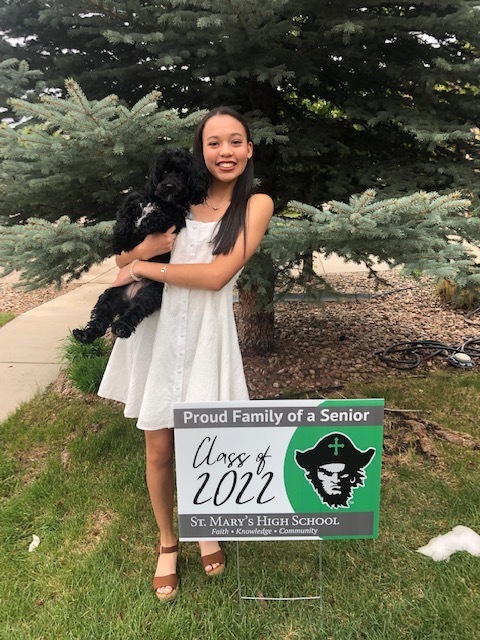 senior with sign and dog